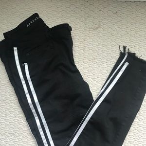 Black demin jeans with silver stripes.